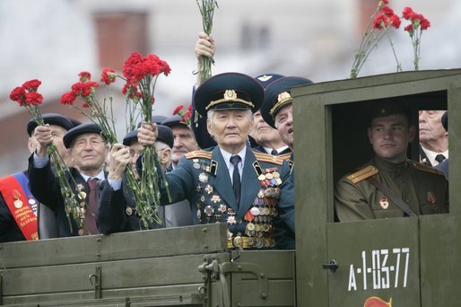 Veterans of Russia's military hold up flowers as they ride through Moscow's Red Square in a parade held to commemorate the 60th Anniversary of the end of World War II Monday, May 9, 2005. White House photo by Eric Draper
