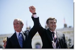 President George W. Bush and President Mikhail Saakashvili of Georgia react to the cheering of thousands of Tbilisi citizens in Freedom Square Tuesday, May 10, 2005. "You are building a democratic society where the rights of minorities are respected, where a free press flourishes, a vigorous opposition is welcome, and unity is achieved through peace," said the President in his remarks. "In this new Georgia, the rule of law will prevail, and freedom will be the birthright of every citizen."  White House photo by Eric Draper
