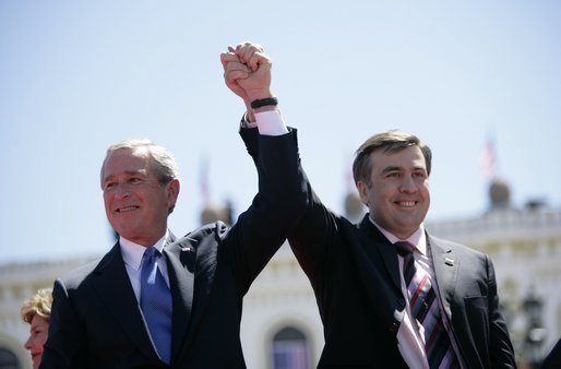 President George W. Bush and President Mikhail Saakashvili of Georgia react to the cheering of thousands of Tbilisi citizens in Freedom Square Tuesday, May 10, 2005. "You are building a democratic society where the rights of minorities are respected, where a free press flourishes, a vigorous opposition is welcome, and unity is achieved through peace," said the President in his remarks. "In this new Georgia, the rule of law will prevail, and freedom will be the birthright of every citizen." White House photo by Eric Draper