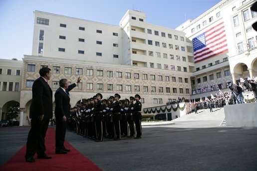 President George W. Bush waves to the crowd as he and Georgian President Mikhail Saakashvili review military troops during President Bush's visit to the Georgian Parliament in Tbilisi Tuesday, May 10, 2005. White House photo by Eric Draper
