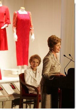 With former First Lady Nancy Reagan looking on, Laura Bush addresses the opening of The Heart Truth’s First Ladies Red Dress Collection Thursday, May 12, 2005, at the John F. Kennedy Center for the Performing Arts in Washington D.C. Mrs. Bush, the ambassador for The Heart Truth, wore her red Carolina Herrera suit to the Bolshoi Theater in Moscow and to The Heart Truth’s Red Dress Collection Fashion Show 2005 in New York City.  White House photo by Krisanne Johnson