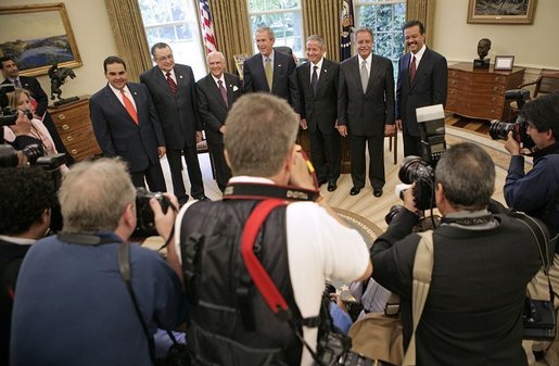 President George W. Bush poses with Presidents from Central America and the Dominican Republic in the Oval Office Thursday, May 12, 2005. From left, they are: El Salvadoran President Antonio Saca, Costa Rican President Abel Pacheco, Nicaraguan President Enrique Bolanos, Honduran President Ricardo Maduro, Guatemalan President Oscar Berger and Dominican Republican President Leonel Fernandez. White House photo by Eric Draper