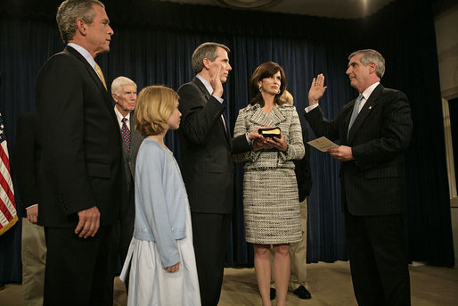 White House Chief of Staff Andrew Card swears in United States Trade Representative Rob Portman during a ceremony attended by the ambassador's family and President George W. Bush at the Dwight D. Eisenhower Executive Office Building Tuesday, May 17, 2005. White House photo by Eric Draper