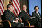 President George W. Bush reaches to Archbishop Charles J Chaput of Denver at the National Catholic Prayer Breakfast in Washington, D.C., Friday, May 20, 2005. Also pictured is Joseph Cella. White House photo by Eric Draper