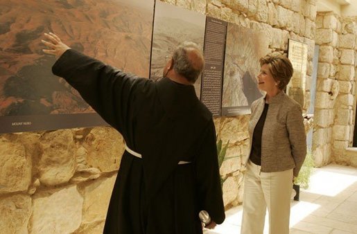 Father Michele Piccirillo, head of the Franciscan Archeology Society, gives Laura Bush a tour of the Interpretative Center at Mount Nebo in Jordan Saturday, May 21, 2005. Mount Nebo is the holy site where Moses is believed to have died. White House photo by Krisanne Johnson
