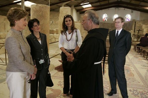 Father Michele Piccirillo, head of the Franciscan Archeology Society leads a tour for: from left, Laura Bush; Anita McBride, Mrs. Bush's Chief of Staff; Luma Kawar, the wife off the Jordanian Ambassador to the U.S.; and David Hale, the U.S. Charge in Jordan, in the Basilica on top of Mount Nebo in Jordan Saturday, May 21, 2005. White House photo by Krisanne Johnson