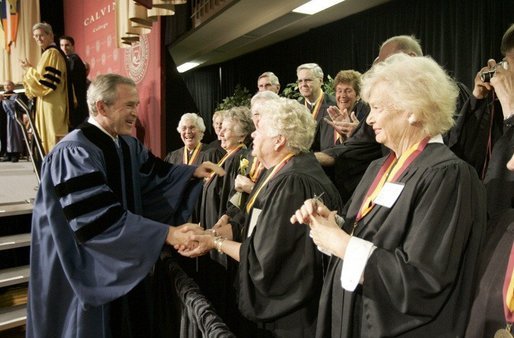 President George W. Bush greets members of the 50th anniversary class of Calvin College after giving a commencement address at Calvin College in Grand Rapids, Michigan on Saturday May 21. White House photo by Paul Morse