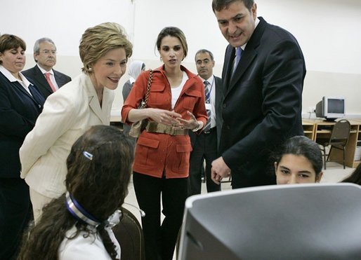 Laura Bush and Queen Raina Al-Abdullah, wife of King Abdullah of Jordan, center, talk with students during a computer lab at the Discovery School of Swaifiyeh Secondary School in Amman, Jordan, Sunday, May 22, 2005. White House photo by Krisanne Johnson
