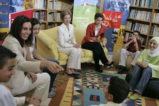 Soraya Sulti, regional director of INJAZ, left, and students at the Discovery School of Swaifiyeh Secondary School in Amman, Jordan, share their experiences with INJAZ with Laura Bush and Queen Raina, center right, May 22, 2005. INJAZ promotes entrepreneurship and community leadership among Jordan’s youth by teaching entrepreneurship, business ethics, leadership and community involvement. White House photo by Krisanne Johnson