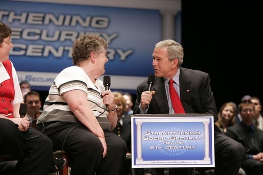 President George W. Bush talks with a fellow stage participant during a conversation about strengthening Social Security at Greece Athena Middle and High School in Greece, N.Y., Tuesday, May 24, 2005. White House photo by Paul Morse