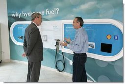 President George W. Bush is led by Rick Scott, Operations and Safety Coordinator, Shell Hydrogen, L.L.C., through the visitor center exhibit at a Washington D.C. Shell Service Station equipped with a hydrogen fueling station Wednesday, May 25, 2005. The station is the first integrated gasoline/hydrogen station in North America and will service a fleet of six GM fuel cell vehicles, which were developed in collaboration with the Department of Energy.  White House photo by Paul Morse