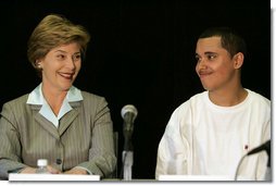 Laura Bush talks with Freddy Martinez, 17, during a roundtable discussion on stopping violent crime in Chicago on June 2, 2005. CeaseFire Chicago is a public health initiative that works with community partners to reduce violence. White House photo by Krisanne Johnson