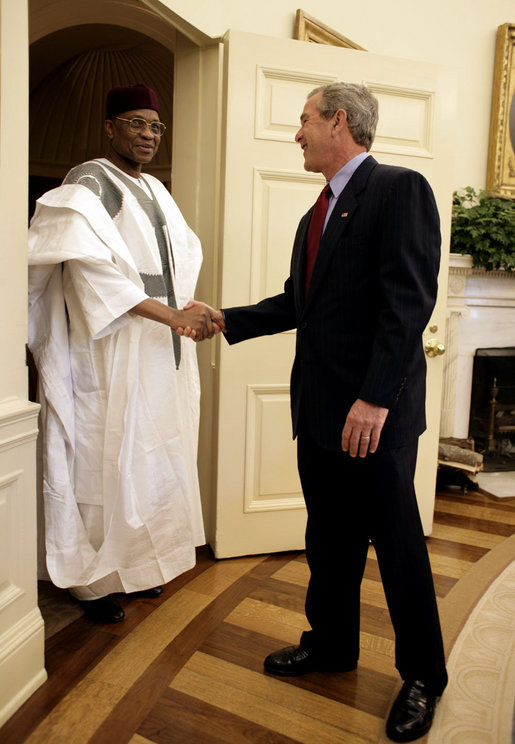 Meeting with the leaders from Mozambique, Botswana, Niger, Ghana and Namibia, President George W. Bush welcomes President Mamadou Tandja of Niger to the Oval Office Monday, June 13, 2005. The leaders discussed a range of topics, including AGOA. "All the Presidents gathered here represent countries that have held democratic elections in the last year," said President Bush. "What a strong statement that these leaders have made about democracy and the importance of democracy on the continent of Africa." White House photo by Eric Draper