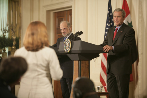 President George W. Bush and Prime Minister Ibrahim Jaafari listen to a question from the media Friday, June 24, 2005, during a press availability in the East Room of the White House. White House photo by Eric Draper