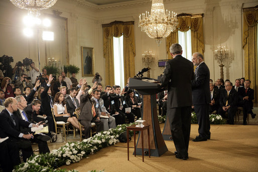 Members of the media raise their hands to President George W. Bush and Iraqi Prime Minister Ibrahim Jaafari during a media availability Friday, June 24. 2005, in the East Room of the White House. White House photo by Eric Draper