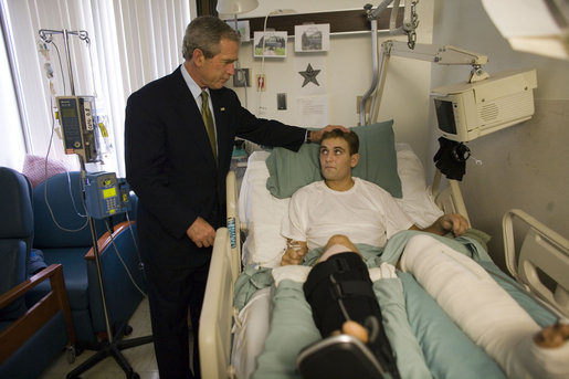 President George W. Bush spends a moment with Cpl. Cole Hansen of Canby, Minn., during a visit to Walter Reed Army Medical Center Friday, July 1, 2005. Cpl. Hansen is recovering from wounds received while serving in Operation Iraqi Freedom. White House photo by Eric Draper