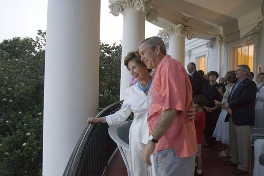 On July 4, 2005, President and Mrs. Bush listen as a South Lawn crowd sings "Happy Birthday" at the White House in celebration of the President's upcoming birthday on July 6. White House photo by Krisanne Johnson