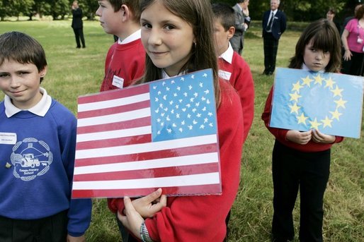 Children carrying US flags welcome Mrs. Bush and other spouses to the Spouses Program, hosted by Mrs. Cherie Blair, wife of Prime Minister Tony Blair of England, during the G8 Summit in Scotland Thursday, July 7, 2005. White House photo by Krisanne Johnson