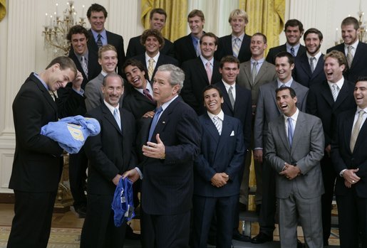 President Bush reacts with a joke as he is given a Speedo swim suit Tuesday, July 12, 2005 by members of the UCLA men's waterpolo team, who were attending ceremonies to honor NCAA 2004-2005 national championship teams. White House photo by David Bohrer