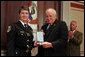 Vice President Dick Cheney awards Deputy Jennifer Fulford, of Florida's Orange County Sheriff's Office, the Public Safety Officer Medal of Valor Award Thursday, July 14, 2005, during a ceremony in the Dwight D. Eisenhower Executive Office Building. Deputy Fulford responded to a burglary in progress call May 5, 2004, after an 8-year-old boy called 911 so say that "strange men" were in his home with weapons and that he and his sister were hiding inside a van in the garage. Deputy Fulford entered the garage to check on the children, and two men emerged from the house firing their weapons. Deputy Fulford, trapped in the garage, returned fire. She was struck a total of ten times, including in her shooting hand. She was still able to retrieve her weapon with her other hand and continue firing until both gunmen went to the ground. The children were kept safe and unharmed throughout the incident. White House photo by David Bohrer