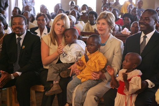 Laura Bush and daughter Jenna sit with children as they visit the Kagarama Church, Thursday, July 14, 2005, in Kigali, Rwanda. White House photo by Krisanne Johnson