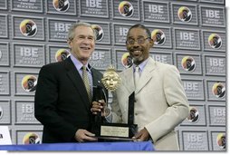 President George W. Bush receives the Black Expo Lifetime Achievement Award by Black Expo Chairman Arvis Dawson during the Indiana Black Expo Corporate Luncheon in Indianapolis, Indiana, Thursday, July 14, 2005.  White House photo by Eric Draper