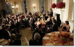 President George W. Bush addresses guests during the official dinner for India's Prime Minister Dr. Manmohan Singh, in the State Dining Room, Monday evening, July 18, 2005, at the White House.  White House photo by Eric Draper