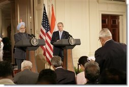 President George W. Bush and India's Prime Minister Dr. Manmohan Singh, listen to a reporter's question during a joint news conference, Monday, July 18, 2005, in the East Room of the White House.  White House photo by Eric Draper
