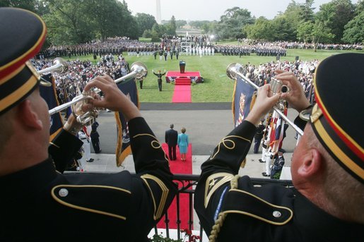 President George W. Bush and Laura Bush are seen waiting below, Monday, July 18, 2005 at the White House, as trumpeters signal the official arrival of India Prime Minister Dr. Manmohan Singh. White House photo by David Bohrer
