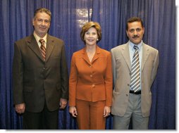 Laura Bush visits with Talib Aziz M. Zaini, Minister of Youth and Sports for Iraq, left, and Abbas Kadim Ibrahim, Director General, Ministry of Youth and Sports for Iraq, at the National Youth Summit in Washington, D.C., Friday, July 29, 2005. The Iraqi officials attended the summit to increase their understanding of youth development. White House photo by Krisanne Johnson