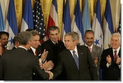 President George W. Bush shakes hands with legislators, administration officials and guests, Tuesday, Aug. 2. 2005 in the East room of the White House, after the signing ceremony for the CAFTA Implementation Act.  White House photo by Krisanne Johnson