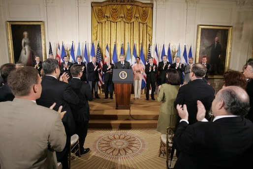 President George W. Bush acknowledges the applause of legislators, administration officials and guests, Tuesday, Aug. 2. 2005 in the East room of the White House, at the signing ceremony for the CAFTA Implementation Act. White House photo by Paul Morse