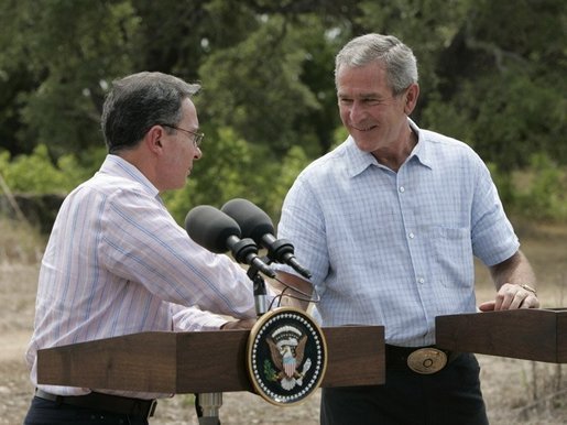 President George W. Bush and Colombian President Alvaro Uribe shake hands during a joint press conference at the President's Central Texas ranch in Crawford, Texas, on August 4, 2005. White House photo by Paul Morse