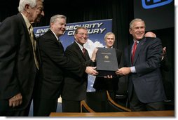 President George W. Bush holds the box containing the energy bill after signing the H.R. 6, The Energy Policy Act of 2005 at Sandia National Laboratory in Albuquerque, New Mexico, Monday, Aug. 8, 2005. Also on stage from left are Congressman Ralph Hall (R, TX), Congressman Joe Barton (R, TX), Senator Pete Domenici (R, NM) and Senator Jeff Bingaman (D, NM).  White House photo by Eric Draper