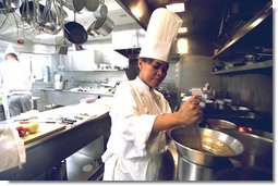 Chef Cristeta "Cris" Comerford prepares a meal inside the White House kitchen in this July 17, 2002 photo. Mrs. Laura Bush announced on August 14, 2005 that Comerford has been named the White House Executive Chef. Comerford is the first woman to serve in the job.  White House photo by Tina Hager