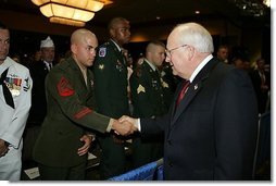 Vice President Dick Cheney shakes the hand of Sgt. Justin Genovese, US Marine Corps, who was wounded in battle in Iraq, August 4, 2004. The vice president spoke to he and other the attendees at the 73rd National Convention of the Military Order of the Purple Heart in Springfield, Missourri, Thursday, August 18, 2005. The organization was formed in 1932 for the protection and mutual interest of all who have, as a result of being wounded in combat, recieved the Purple Heart.  White House photo by David Bohrer