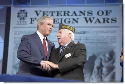 President George W. Bush talks with Veterans of Foreign Wars Commander-in-chief John Furgess during his visit to the VFW national convention in Salt Lake City, Utah, August 22, 2005. White House photo by Paul Morse