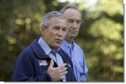 Standing with Idaho Governor Dirk Kempthorne, President George W. Bush talks with the press in Donnelly, Idaho, Tuesday, Aug. 23, 2005.  White House photo by Paul Morse