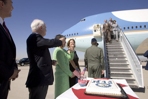 President George W. Bush and Laura Bush are greeted by Arizona Senator John McCain after arriving Monday, Aug. 29, 2005, at Luke Air Force Base near Phoenix. The President later addressed 400 guests at the Pueblo El Mirage RV Resort and Country Club, highlighting benefits of the new Medicare Prescription Drug coverage. White House photo by Paul Morse