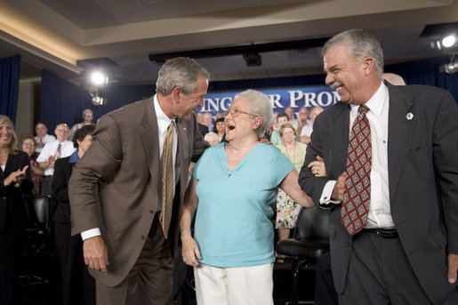President George W. Bush and Margaret Cantrell break out in laughter on stage Monday, Aug. 29, 2005, at the Pueblo El Mirage RV Resort and Country Club in El Mirage, Arizona. The 82-year-old retired Scottsdale grandmother was on hand to lend support to the President's Conversation on Medicare. White House photo by Paul Morse