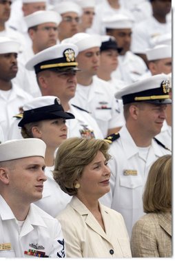 Laura Bush listens to President George W. Bush speak during a ceremony to commemorate the 60th anniversary of V-J Day at the Naval Air Station in San Diego, Calif., August 30, 2005. White House photo by Paul Morse