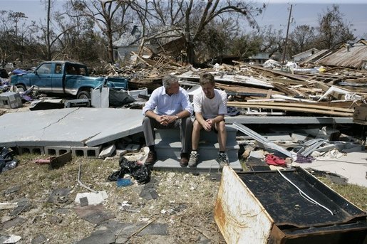 President George W. Bush spends a moment with a Patrick Wright during his walking tour Friday, Sept. 2, 2005, of Biloxi, Miss. "You know, there's a lot of sadness, of course," said the President of the devastated area. "But there's also a spirit here in Mississippi that is uplifting." White House photo by Eric Draper