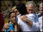 President George W. Bush comforts Bronwynne Bassier, right, and her sister Kim after landing in Biloxi, Miss., Friday Sept. 2, 2005, as part of his tour of the Hurricane Katrina-ravaged Gulf Coast. Their family lost everything in the wake of the devastating storm. White House photo by Eric Draper