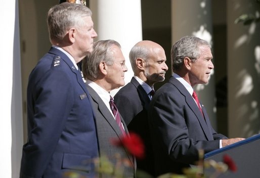 President George W. Bush speaks to the nation during a weekly radio address, live from the Rose Garden at the White House in Washington, D.C., September 3, 2005. Accompanying the president are (L to R) Chairman of the Joint Chiefs of Staff, General Richard Myers, Secretary of Defense Donald Rumsfeld and Homeland Secretary Michael Chertoff. White House photo by Paul Morse