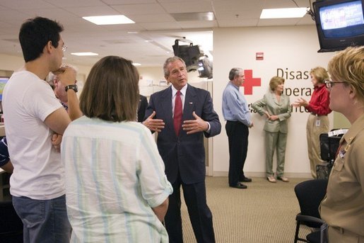 President George W. Bush talks with employees and volunteers during a visit of the Red Cross in Washington, D.C. on Sunday September 4, 2005. The President and Mrs. Laura Bush visited Red Cross headquarters to view relief efforts in the aftermath of hurricane Katrina. White House photo by Paul Morse