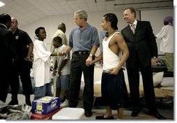 President George W. Bush visits with children inside the Bethany World Prayer Center shelter, Monday, Sept. 5, 2005 in Baton Rouge, Louisiana. The facility is housing hundreds of people displaced by Hurricane Katrina.  White House photo by Eric Draper