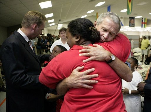 President George W. Bush hugs a woman displaced by Hurricane Katrina during his visit Monday, Sept. 5, 2005 at the Bethany World Prayer Center shelter in Baton Rouge, La. White House photo by Eric Draper