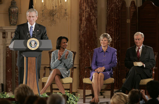 President George W. Bush addresses an audience attending the swearing-in ceremony of Karen Hughes, Friday, Sept. 9, 2005 at the State Department in Washington, to be the Under Secretary of State for Public Diplomacy. Karen Hughes is seen with U.S. Secretary of State Condoleezza Rice and her husband Jerry Hughes. White House photo by Paul Morse