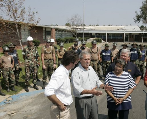 President George W. Bush is joined by Gulfport, Miss., Mayor Brent Warr, left; Twenty-Eighth Street Elementary School principal Phyllis A Bourn and Mississippi Gov. Haley Barbour, right, Monday, Sept. 12, 2005, outside the Twenty-Eighth Street Elementary School in Gulfport, where U.S. and Mexico aid workers are helping to clean-up the school devastated by Hurricane Katrina. White House photo by Paul Morse