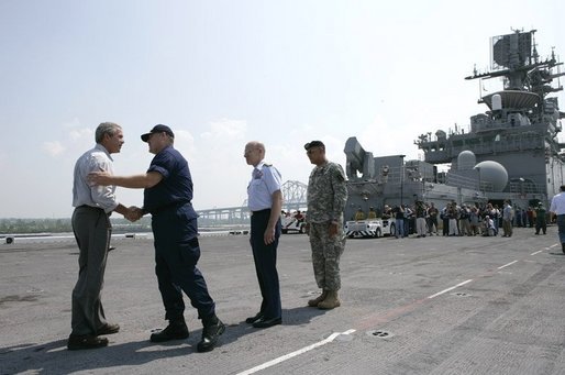 President George W. Bush is greeted by U.S. Coast Guard Vice Admiral Thad Allen, Tuesday, Sept. 20, 2005 aboard the USS Iwo Jima in New Orleans, La., joined by Rear Admiral Robert Duncan and U.S. Army Lt. General Russel Honore, right. White House photo by Eric Draper